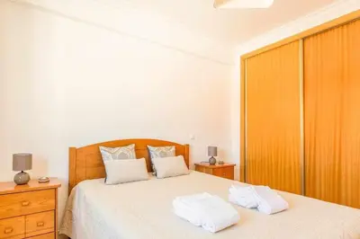 a bedroom with a bed with two towels on it at Albufeira Old Town Two bedroom Apartment Center in Albufeira