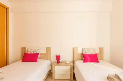 two beds in a room with red pillows on them at Albufeira Old Town Two bedroom Apartment Center in Albufeira