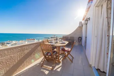 a table and chairs on a balcony with a view of the beach at #017 T2 Rossio by Home Holidays in Albufeira