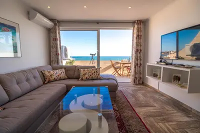 a living room with a couch and a view of the ocean at #017 T2 Rossio by Home Holidays in Albufeira