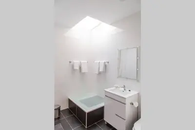 a white bathroom with a sink and a mirror at REMODELED APARTMENT IN THE CITY CENTER. (FARO) in Faro