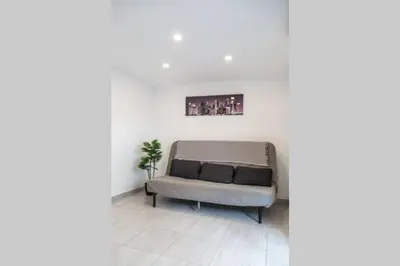 a couch in a living room with a picture on the wall at REMODELED APARTMENT IN THE CITY CENTER. (FARO) in Faro