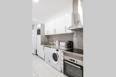 a kitchen with a washing machine and a washer at REMODELED APARTMENT IN THE CITY CENTER. (FARO) in Faro