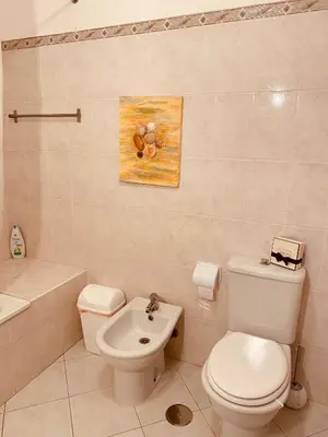a bathroom with a toilet and a sink at OCEAN VIEW Quartos in Faro