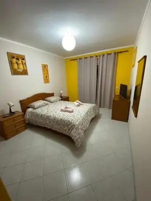 a bedroom with a bed with two towels on it at OCEAN VIEW Quartos in Faro