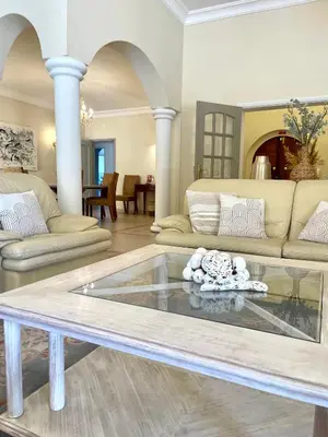 a living room with couches and a glass table at Magellan House in Vilamoura