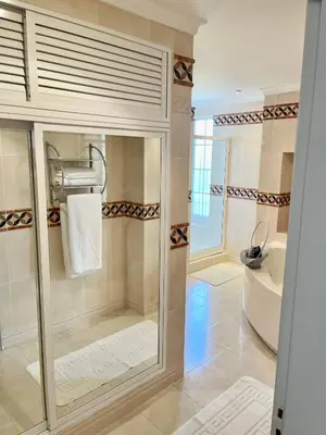 a bathroom with a shower and a tub and a toilet at Magellan House in Vilamoura