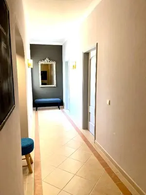 a hallway with a blue chair and a blue bench at Magellan House in Vilamoura
