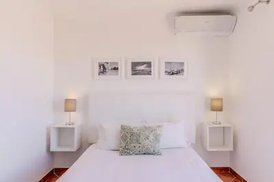 a dining room with a table and a living room at #008 T2 Tenis by Home Holidays in Albufeira