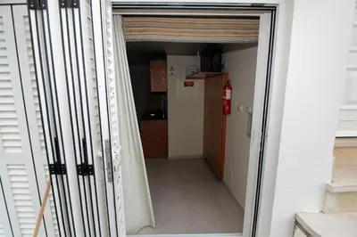 a hallway with a door open to a kitchen at Waves Studio - Albufeira in Albufeira