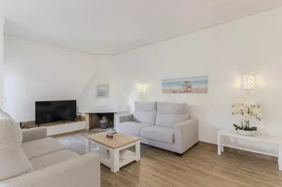 a patio with a table and a lawn at #015 Buganvilia by Home Holidays in Albufeira