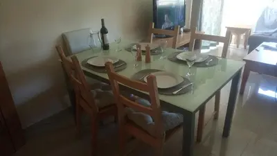 a dining room table with a green table and chairs at Monte da Eira apartments in Albufeira