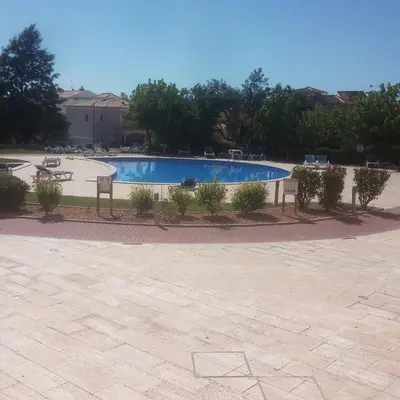 a large swimming pool with plants around it at Monte da Eira apartments in Albufeira