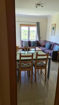 a living room with a table and chairs and a couch at Monte da Eira apartments in Albufeira