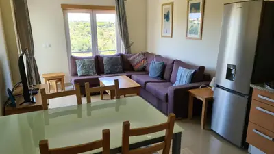 a living room with a purple couch and a table at Monte da Eira apartments in Albufeira