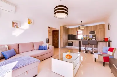 a living room with a couch and a table at Varandas do Mar - Near the beach - Quarteira in Quarteira