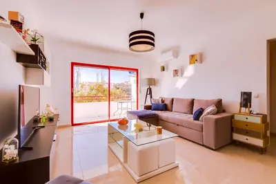 a living room with a couch and a table at Varandas do Mar - Near the beach - Quarteira in Quarteira