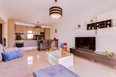 a living room with a couch and a tv at Varandas do Mar - Near the beach - Quarteira in Quarteira