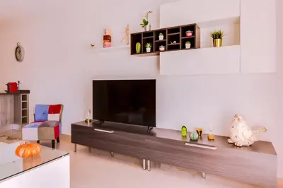 a living room with a large flat screen tv at Varandas do Mar - Near the beach - Quarteira in Quarteira