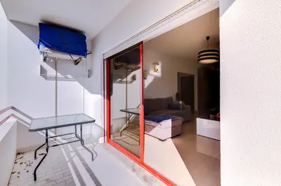 a view of a room with a table and a couch at Varandas do Mar - Near the beach - Quarteira in Quarteira