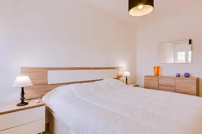 a white bedroom with a large white bed in it at Varandas do Mar - Near the beach - Quarteira in Quarteira