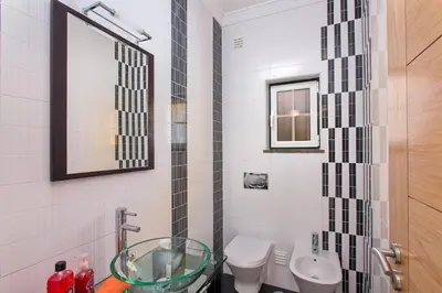 a bathroom with a glass sink and a toilet at Villa Nincha - Heated Pool - Free wi-fi - Air Con in Albufeira
