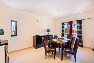 a dining room with a table and chairs at Villa Nincha - Heated Pool - Free wi-fi - Air Con in Albufeira