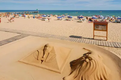 a sand sculpture of a woman on the beach at Villa Nincha - Heated Pool - Free wi-fi - Air Con in Albufeira
