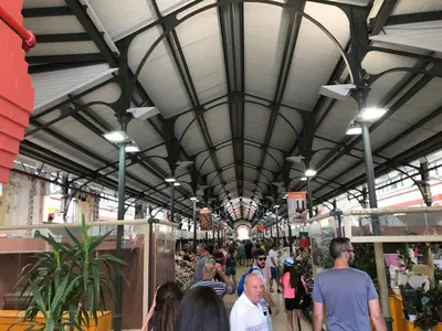 a group of people walking through a shopping mall at Bicas Velhas Studio in Loulé