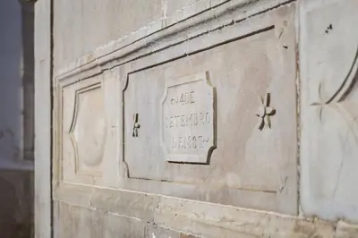 a stone wall with a sign on the side of a building at Bicas Velhas Studio in Loulé