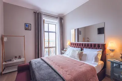 a bedroom with a large bed with a large window at Downtown Loulé in Loulé