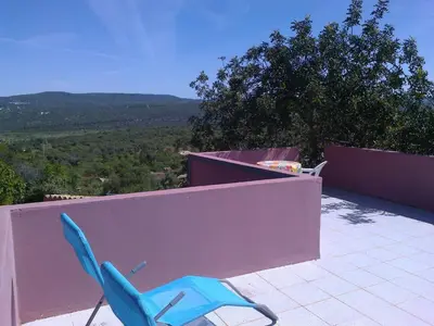a blue chair sitting on top of a balcony at Casa Adega - Quinta Amoreira in Faro