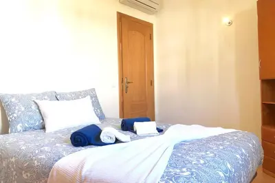 a bedroom with a bed with two towels on it at Albufeira edificio Marina Inn Pateo in Albufeira