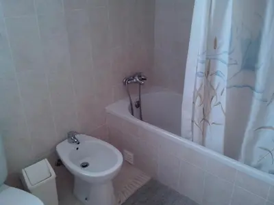 a bathroom with a toilet and a tub and a sink at Albufeira 1 bedroom apartment 5 min from Falesia beach and close to center L in Albufeira
