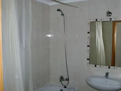 a bathroom with a shower and a sink and a mirror at Albufeira 1 bedroom apartment 5 min from Falesia beach and close to center J in Albufeira