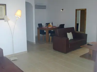 a living room with a couch and a table at Albufeira 1 bedroom apartment 5 min from Falesia beach and close to center J in Albufeira