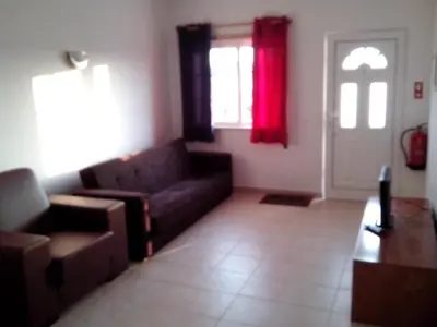 a living room with a couch and a window at Albufeira 2 bedroom apartment 5 min from Falesia beach and close to center H in Albufeira