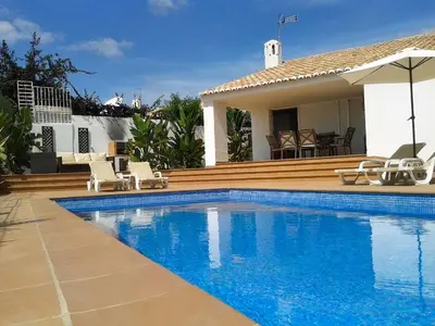 a swimming pool in front of a house at Villa 81 great spot Oura beach, Albufeira in Albufeira
