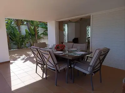 a dining room table with chairs and a table and chairsktop at Villa 81 great spot Oura beach, Albufeira in Albufeira