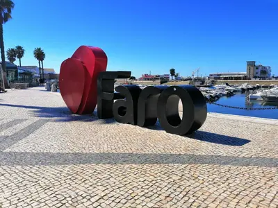 a sculpture of the word park on a sidewalk next to a marina at The Portuguese Element in Faro