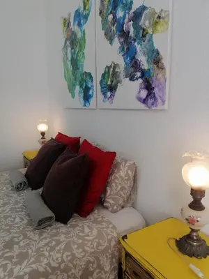 a bedroom with a bed with red and blue pillows at The Portuguese Element in Faro