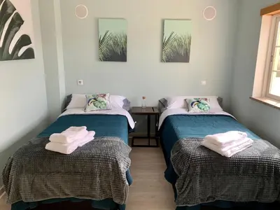 two beds sitting next to each other in a room at Villa Adrian & Brian in Albufeira