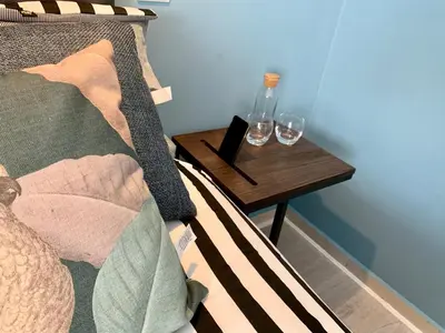a bed with a side table with two glasses on it at Villa Adrian & Brian in Albufeira