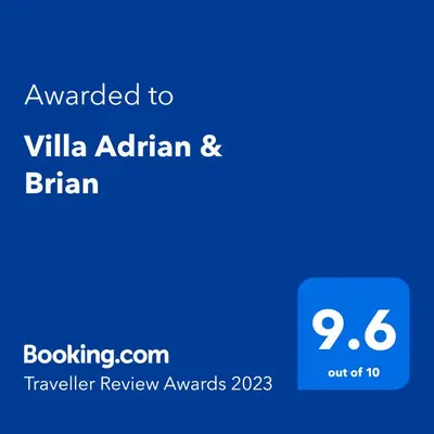 a screenshot of a cell phone with the text awarded to villa afghan at Villa Adrian & Brian in Albufeira