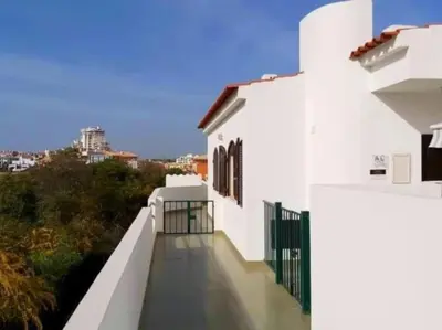 a balcony of a white building with a fence at Areias Apartment by Stay ici Algarve Holiday Rental in Albufeira
