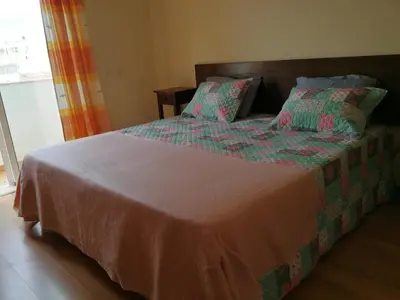 a bedroom with a large bed with two pillows at Jardim Paraiso Apartments in Albufeira