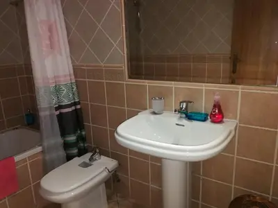 a bathroom with a sink and a toilet and a mirror at Jardim Paraiso Apartments in Albufeira