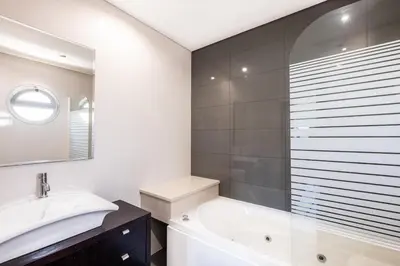 a bathroom with a tub and a sink and a mirror at Villa Orada in Albufeira