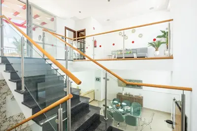 a staircase with glass railings in a house at Villa Orada in Albufeira