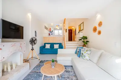 a living room with a white couch and a table at All Dreams Apartment - Urbanização Windmill in Albufeira